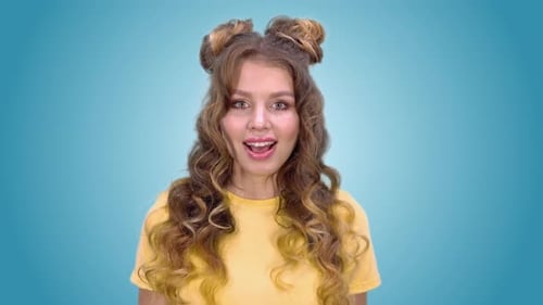Smiling Woman Poses in Studio on Teal and Green