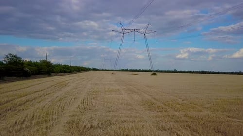 Aerial View Golden Field with Electricity Pylons