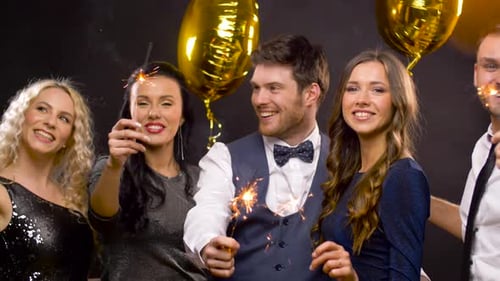 Friends Celebrating with Sparklers and Golden Balloons