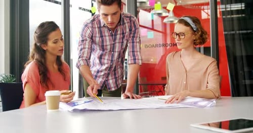 Professionals Working Together on Strategy in Modern Office