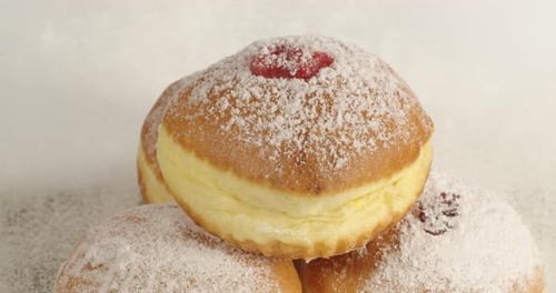 Delicious Doughnuts Stacked with Powdered Sugar and Filling