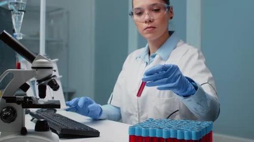 Woman Scientist Examining Test Tube in Laboratory Setting