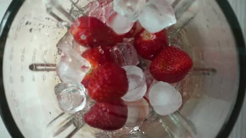 Blending Strawberries and Ice for Smoothie