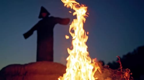 Mysterious Figure by Bonfire at Night