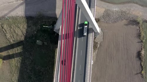 Vehicles Crossing a Cable Stayed Suspension Bridge Crossing a River