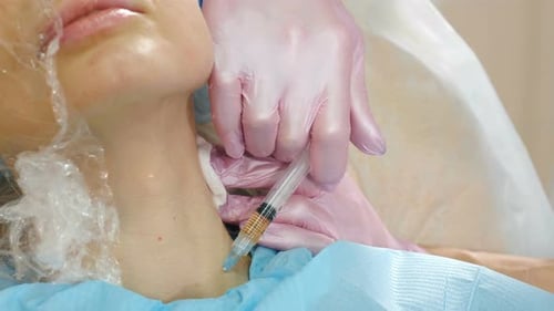 Female Patient Getting Botulinum Toxin Injections in Her Neck in Beauty Salon Beauty Clinic