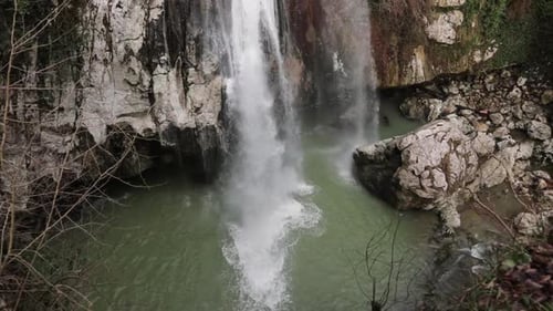 Waterfall in the Rock in the Park on the Stones