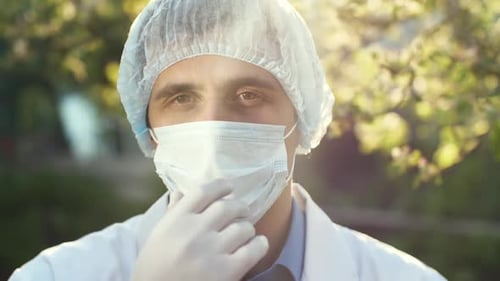 Healthcare Worker Removing Mask Outdoors