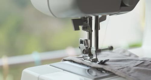 Femme cousue sur tissu avec machine à coudre