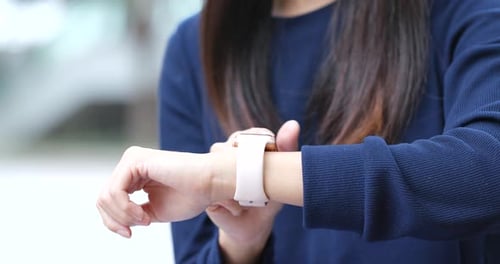 Woman Using Smartwatch in City Environment