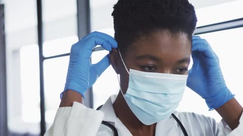 Medical Professional Puts On a Surgical Mask