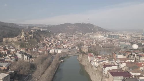 Aerial view of Metekhi church in old Tbilisi located on cliff near river Kura. Georgia 2021 winter