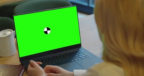Woman Sitting in Cafe at the Table