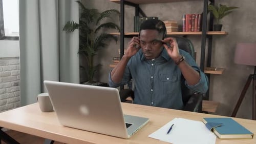 African Man Wearing Headset. Call Center Agent Consult Business Client Online Using Laptop