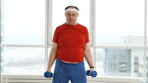 Man Exercising Arms with Dumbbells Indoors