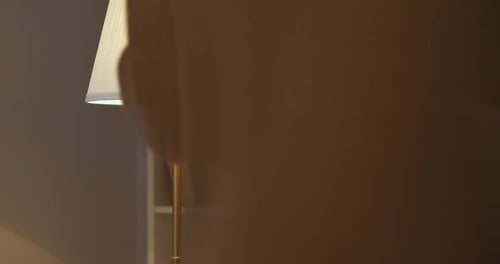 Male Person Is Approaching To Table Floor in Room and Turning Off Pulling Rope Evening and Night