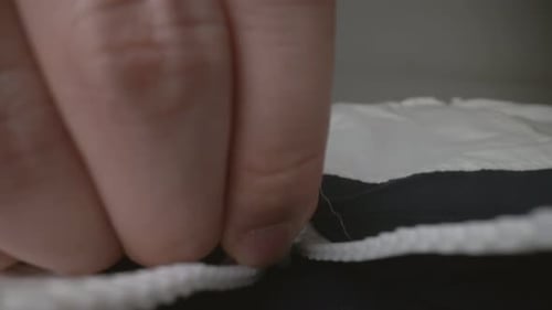 Extreme Close Up Zipper with Hand Unzipping the Sweater Jacket Zipper