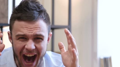 Man Yelling then Calming Down Indoors