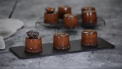 Hand Decorates Chocolate Cake with Garnish