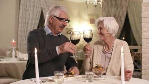 60-Something Caucasian Couple Drinking Wine on Romantic Date in Restaurant