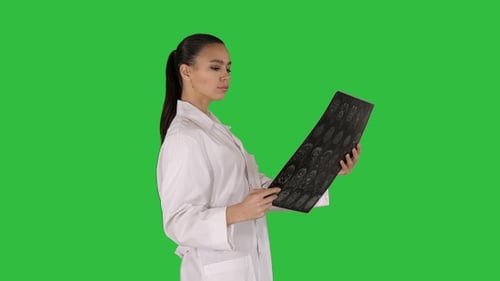 Female Doctor Reviewing X-ray Film on Green Screen