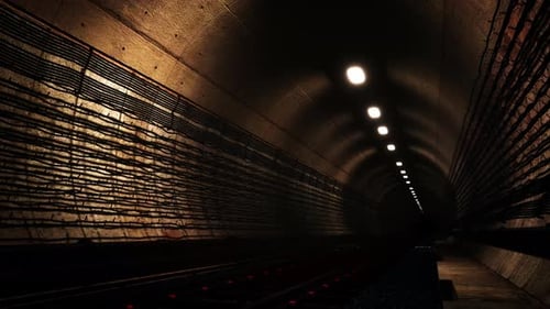 Dark Industrial Tunnel Railway Journey with Overhead Lights Loop