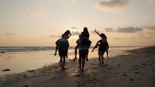 Young riding on the back male on the beach
