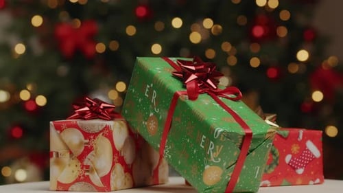 Festive Christmas Gifts with Decorated Tree Background