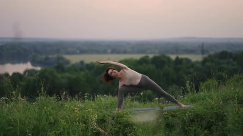 Woman Practicing Yoga Outdoors in Nature