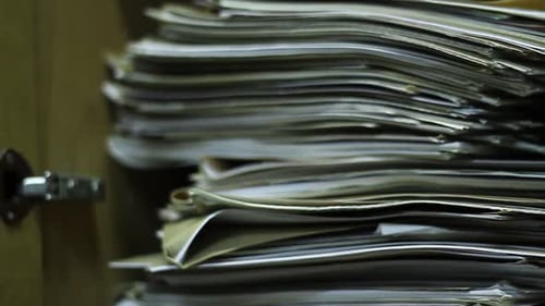 Overflowing Filing Cabinet Full of Documents and Files