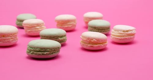 Colorful Macarons Displayed on Pink Surface