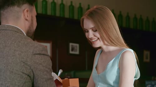 Woman Receives Gift from Man
