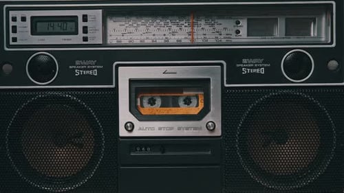 Vintage Yellow Audio Cassette Tape Rotates in Deck of an Old Tape Recorder