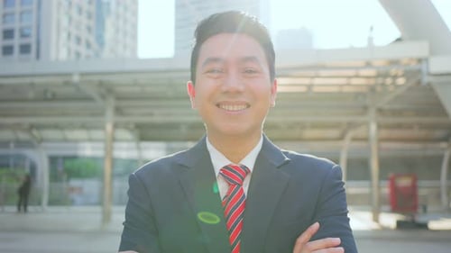 Portrait of Asian young smart businessman working in company office in city and look at camera.