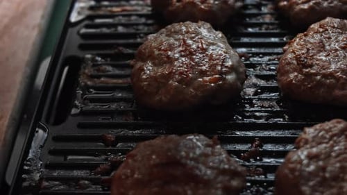 Burger Patties Cooking on Grill Indoors