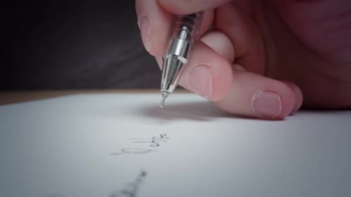 Man Writes with Black Pen on White Clean Page Lying on Table