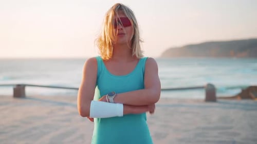 Confident Woman Posing on Beach at Sunset