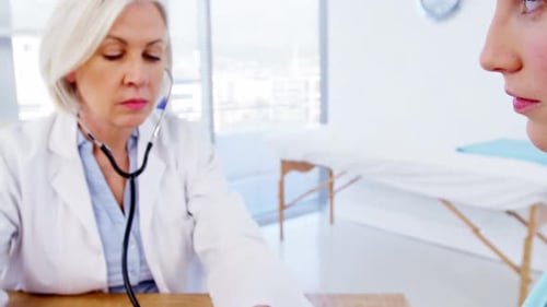 Doctor Checks Patient's Blood Pressure in Office