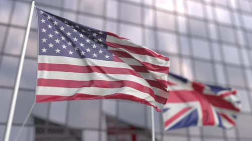 Waving Flags of the USA and the UK at Modern Skyscraper
