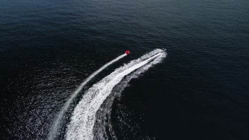 Jet Ski Pulling Raft Across Open Ocean Waters