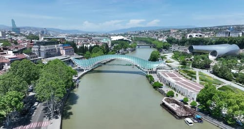 Aerial view of Tbilisi city central park and Bridge of Peace. Beautiful cityscape of old Tbilisi