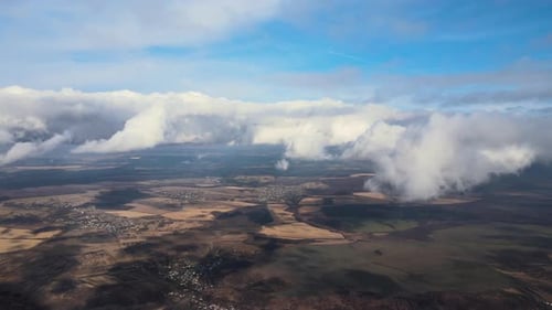 Aerial View From High Altitude of Earth Covered with Puffy Rainy Clouds Forming Before Rainstorm