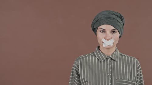 Woman with Tape on Mouth