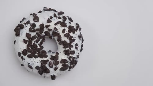 Donut with White Icing and Cookie Crumbles