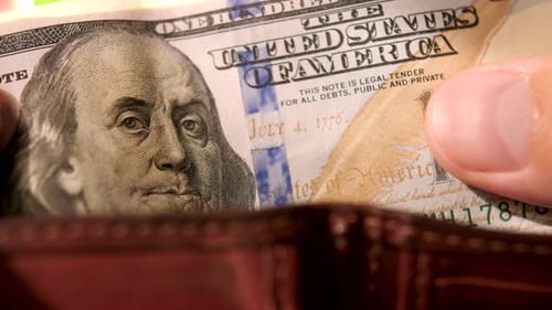 Fingers Recalculating Bank Notes Ben Franklin with Sign $100