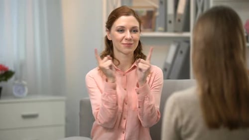 Two Women Communicating Using Sign Language Indoors