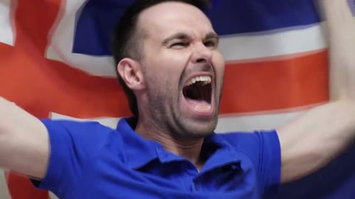 Man Shouting and Holding Flag