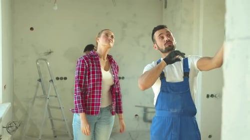 Builder Shows a Repair To a Woman
