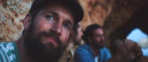 Three friends and the dog chilling and relaxing on the beach