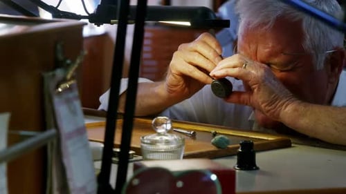 Horologist repairing a watch